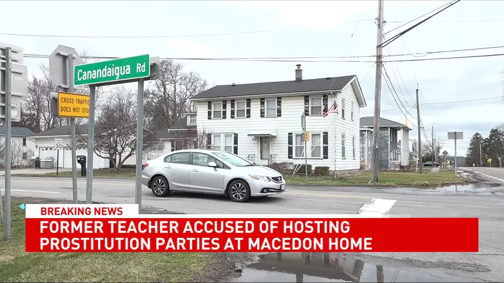 A street view of Canandaigua Road with a breaking news banner about a former teacher accused of hosting prostitution parties at a Macedon home.